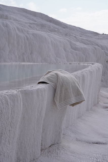 Towel draped over a stone ledge in a white, textured landscape
