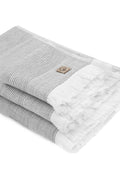 Gray and white towel with a brand logo on a white background