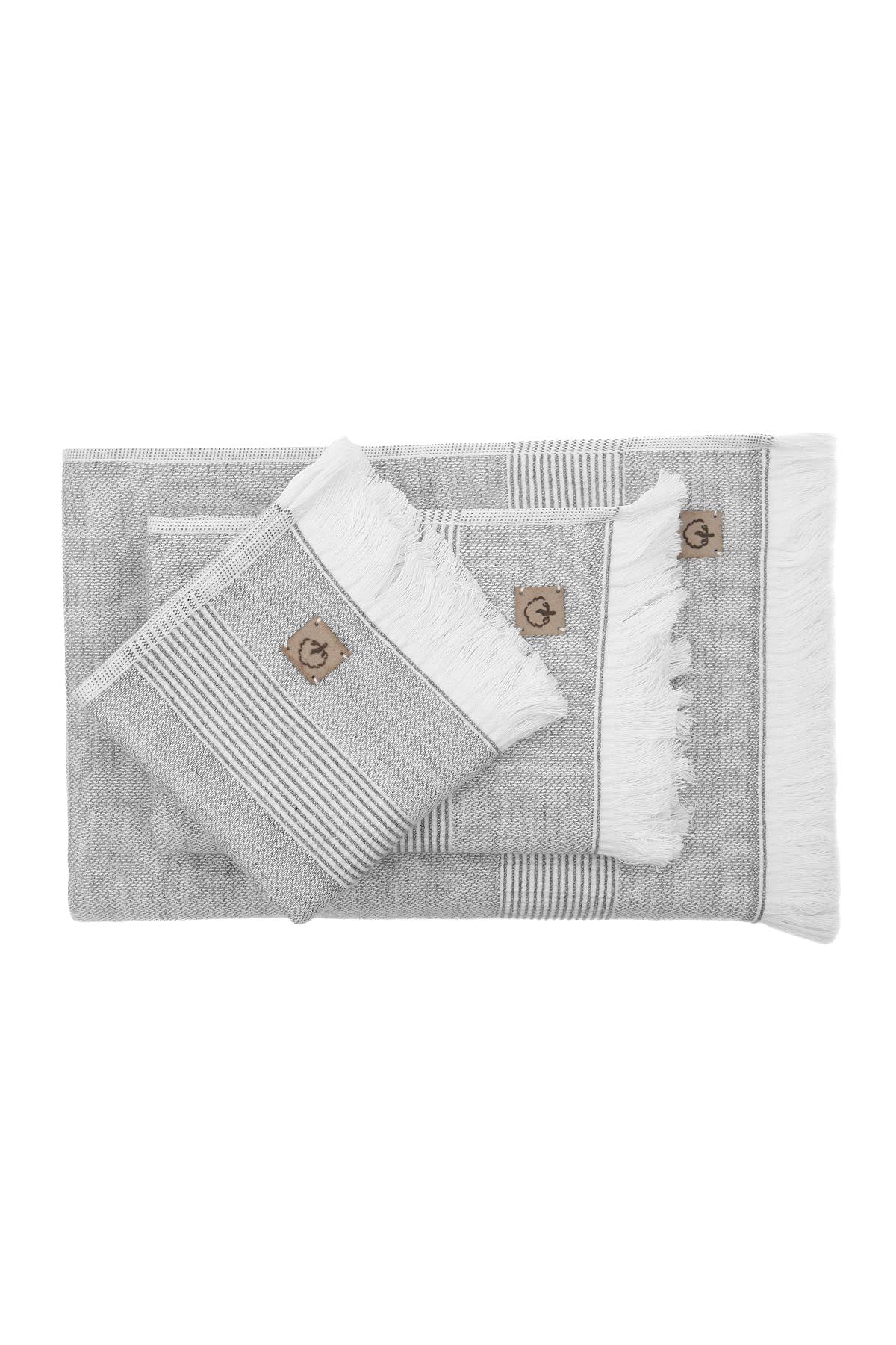 Top view of the three-piece Hasna Organic Aegean Cotton and Linen Bath Set in Grey Haze, showcasing the arrangement, texture, and soft neutral tone of the towels