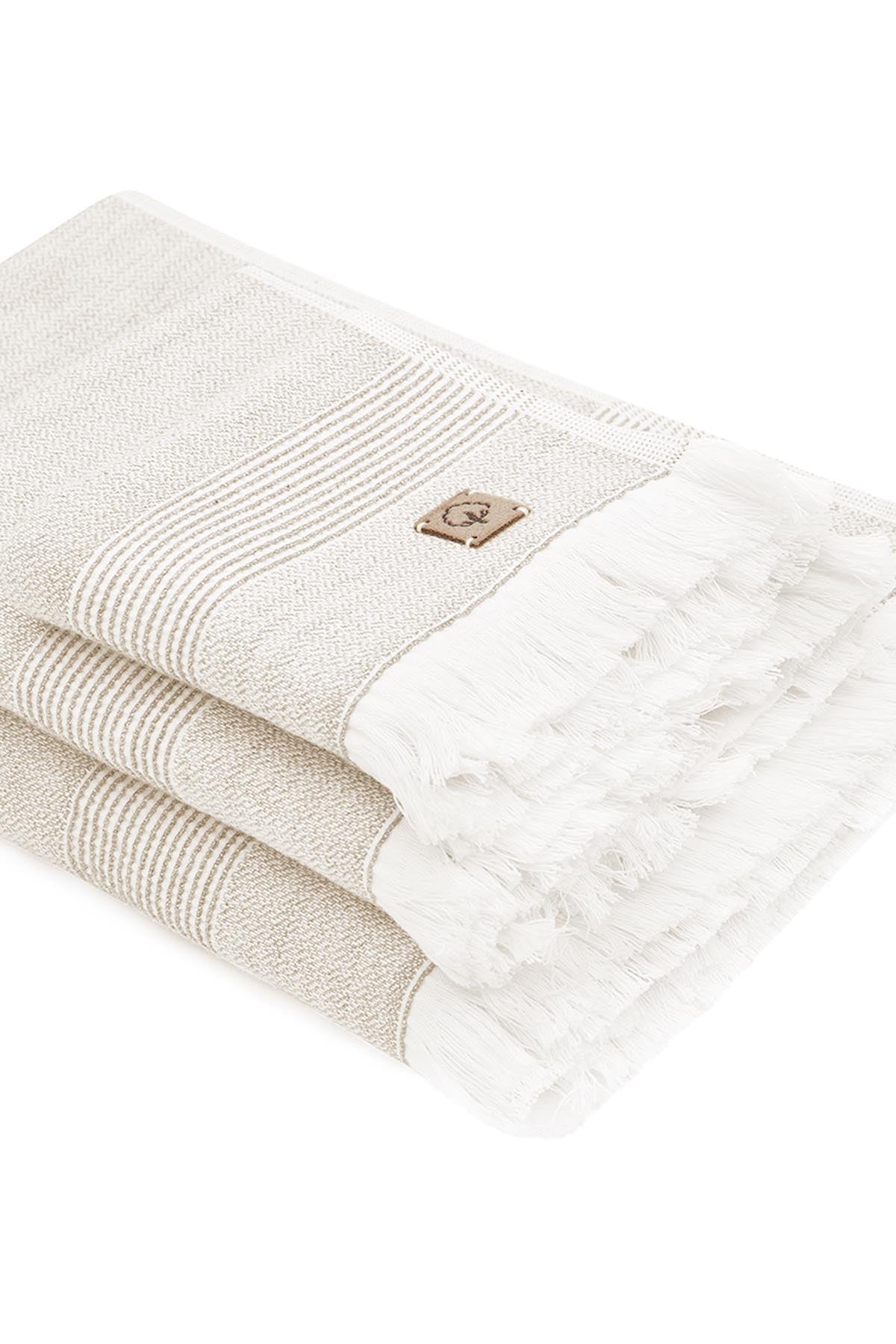 Stack of beige towels with a brand logo on a white background