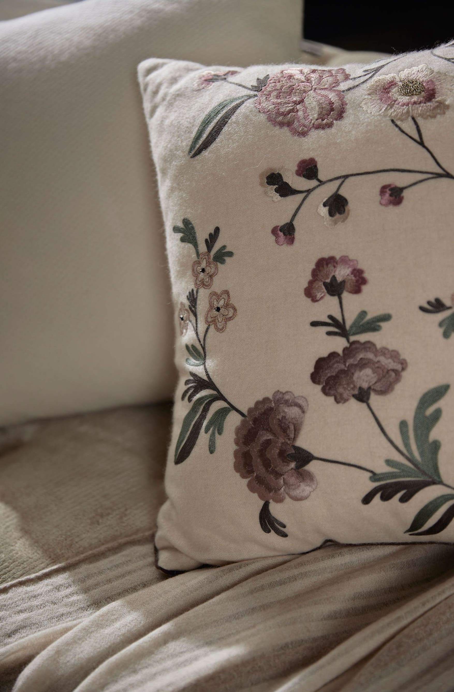 Luxury cushion featuring an elegant floral pattern, showcasing rich texture and design.