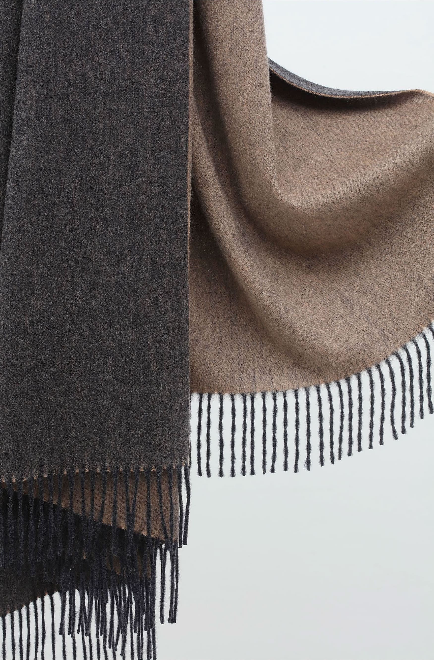 Double-sided throw blanket with dark grey on one side and light brown on the other, showcasing a soft, textured weave.