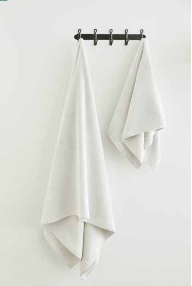 Two Sardes 550-GSM Organic Cotton Towel in white hanging, an organic cotton towel made from 100% GOTS Certified Organic Cotton.

