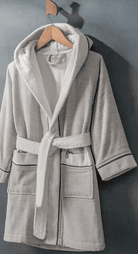 Soft grey HASNA bathrobe featuring a plush, cozy fabric with a belted waist and relaxed fit, perfect for lounging and after-bath comfort