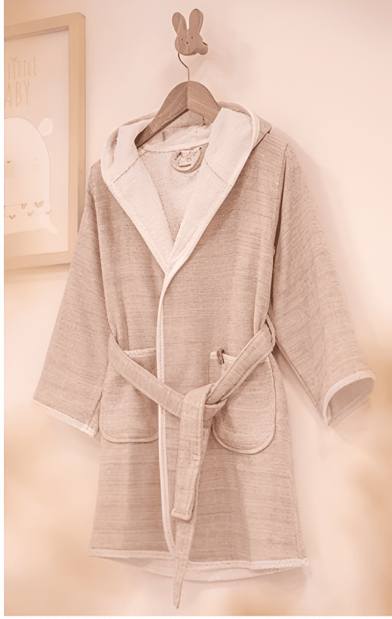 Elegant pink HASNA bathrobe made from luxurious, soft fabric, with a gentle hue and a comfortable belted design for a relaxing experience