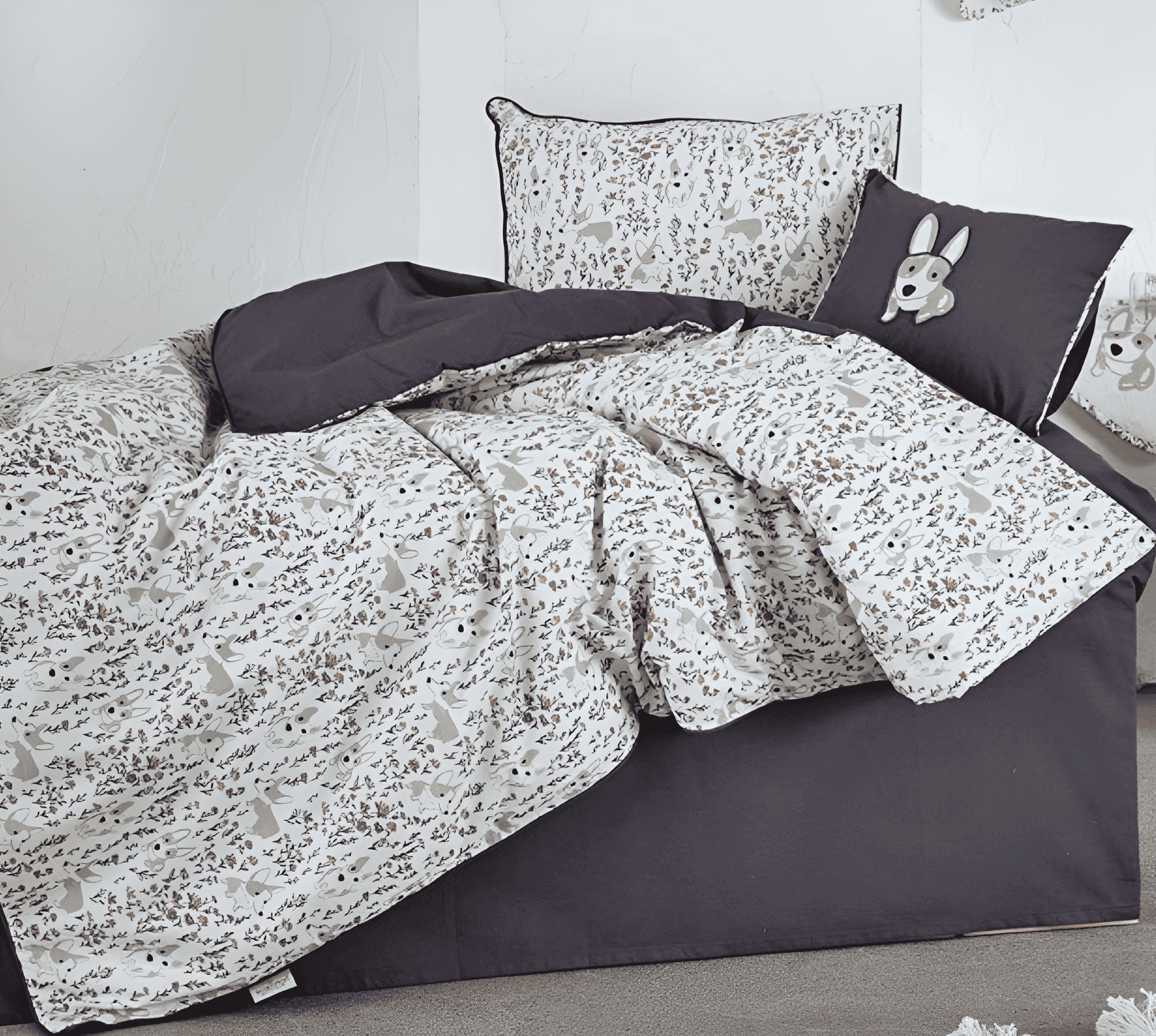 Bedding set with gray and white pattern on a bed