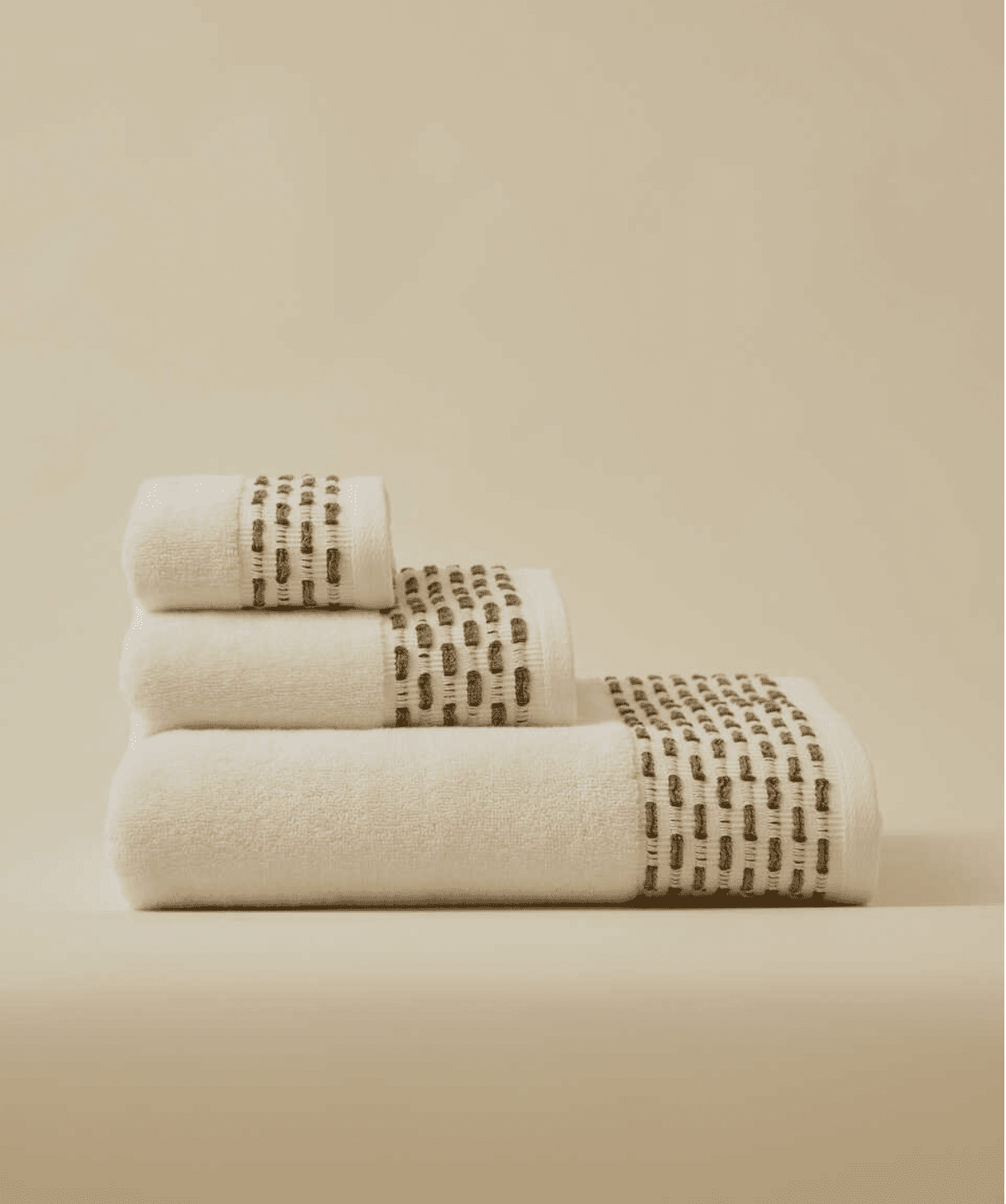 Calm 550-GSM Cotton Towel in ivory and green, an organic cotton towel providing a plush, absorbent texture with a fresh and soothing color combination.