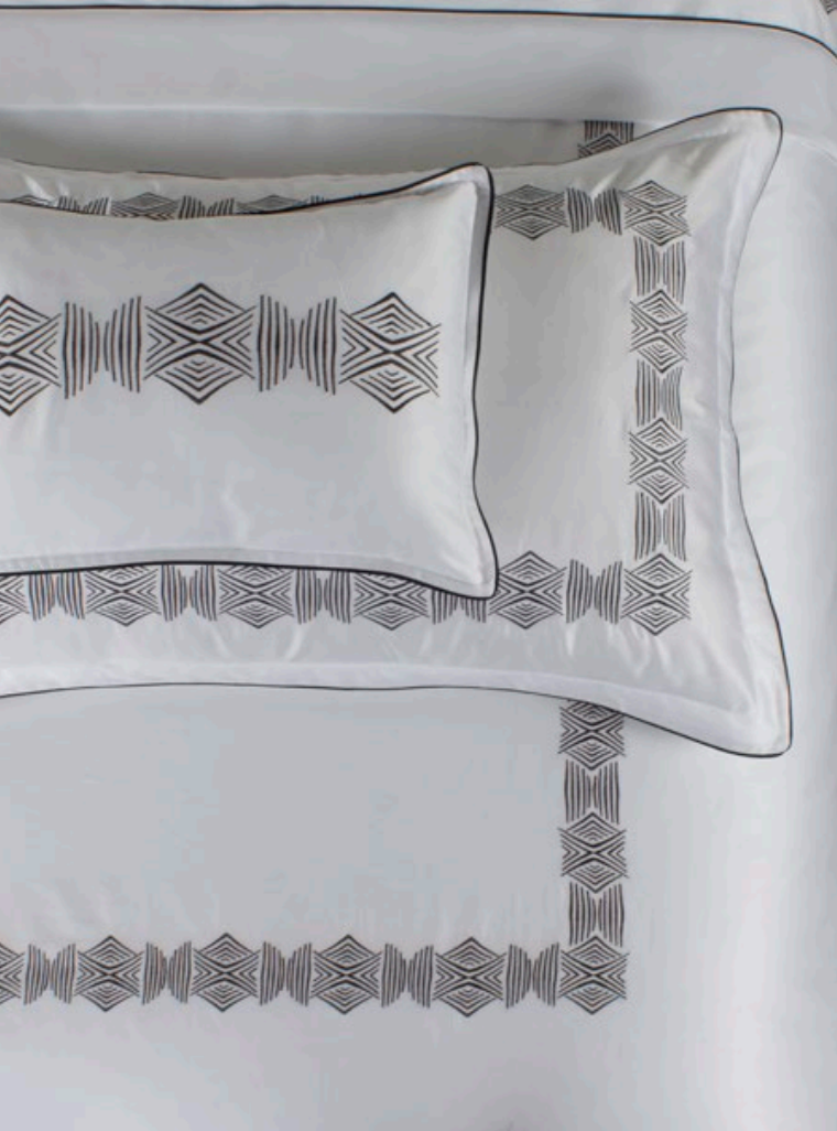A white-n-black pillow with complex embroidery 