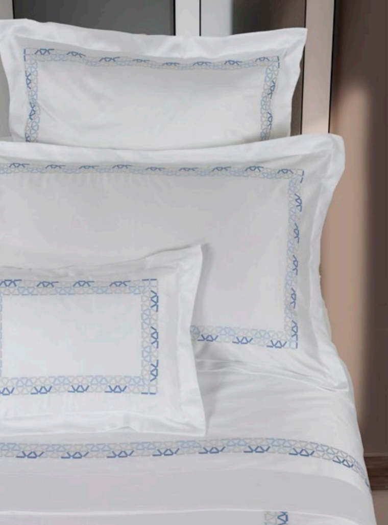 A white-n-blue three-pillow set