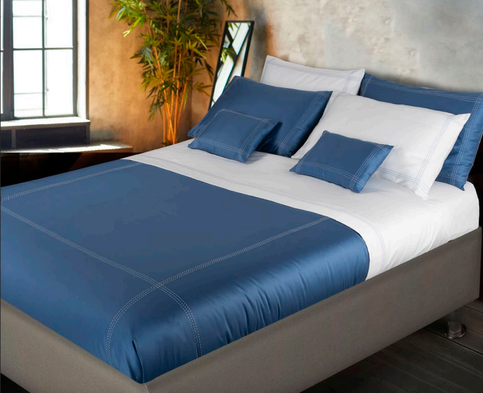 Navy blue bed set with white bed sheets