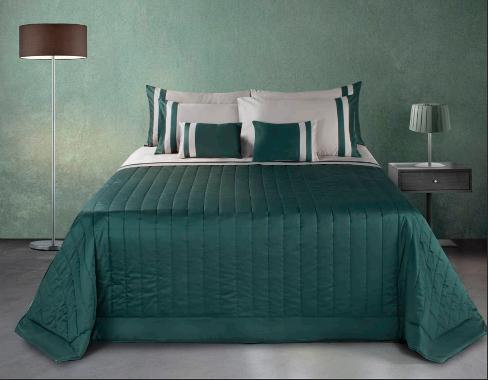 Modern bedroom with emerald green bedding, matching accent pillows, and minimalist lighting.