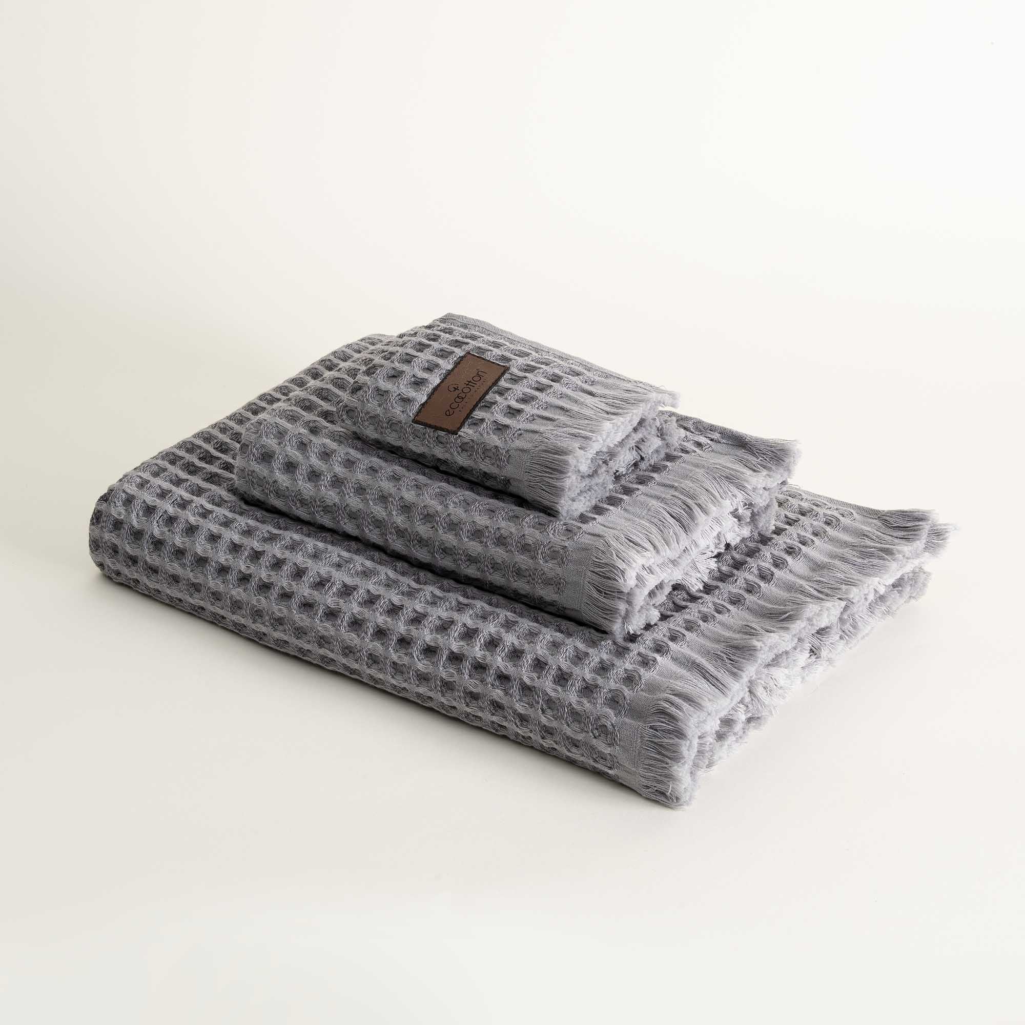 Three-piece Silver Delight Seren Organic Cotton Waffle Bath Set, including bath towel, hand towel, and washcloth, gently arranged to highlight its soft texture and natural, eco-friendly design