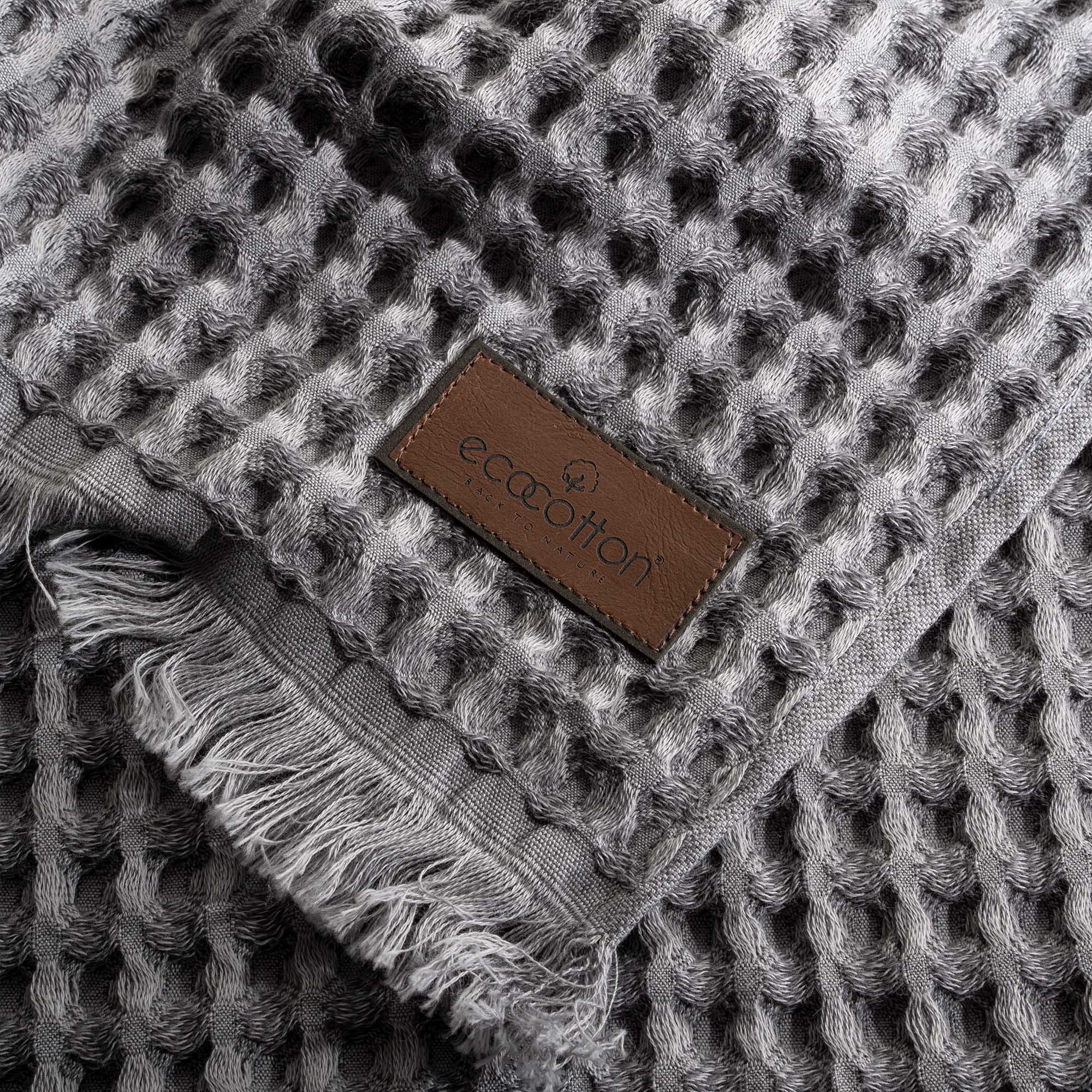 Close-up of Ecocotton tag on Silver Delight Seren organic cotton waffle luxury bath towel, highlighting its sustainable and eco-friendly certification