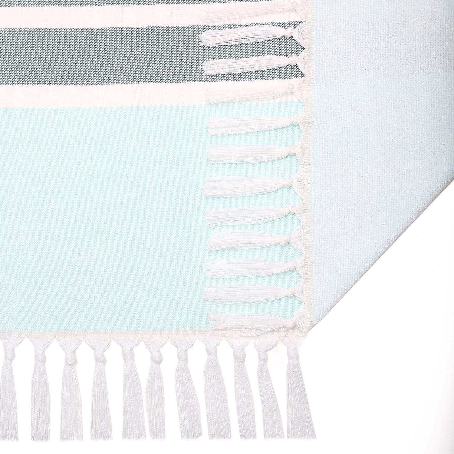 Towel with striped pattern and tassels on a light blue background
