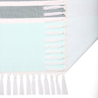 Towel with striped pattern and tassels on a light blue background