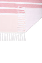 Pink and white striped towel with fringes on a white background