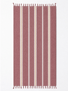 A rectangular woven towel with vertical stripes in dusty rose, cream, and white, finished with small fringe tassels at the top and bottom, shown flat against a plain white background.