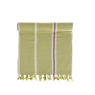 Green towel with striped pattern and fringes on a white background