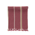 Folded red towel with white and yellow stripes on a white background
