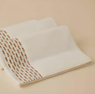 Calm 550-GSM Cotton Towel in ivory and beige, an organic cotton towel offering a soft, plush feel with elegant color contrast for a sophisticated look.