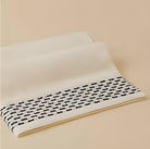 Calm 550-GSM Cotton Towel in ivory and navy, an organic cotton towel combining a soft cotton texture with a stylish color combination for added luxury.