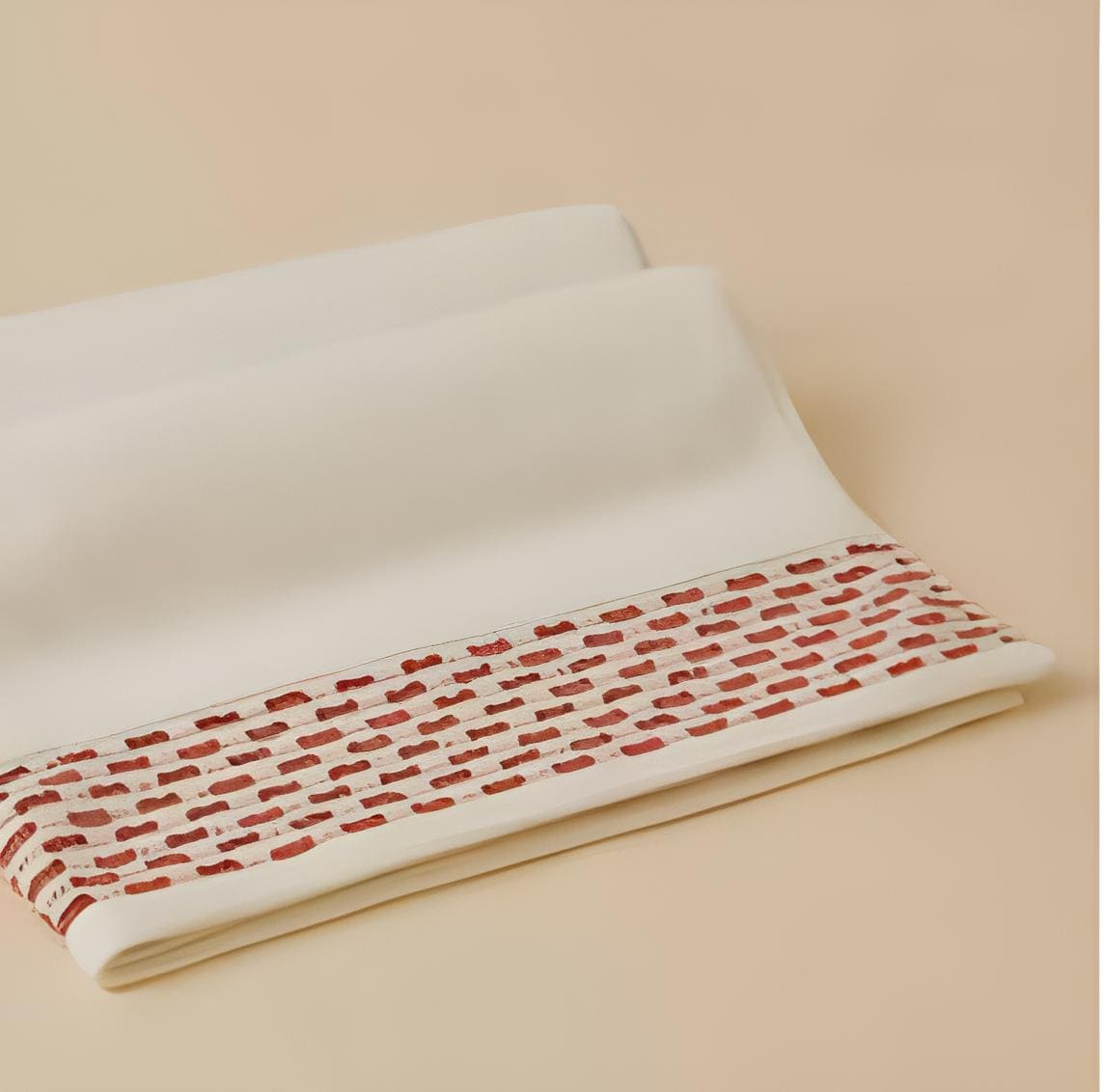 Calm 550-GSM Cotton Towel in ivory and brick, an organic cotton towel featuring a soft cotton feel and a warm, inviting color contrast.