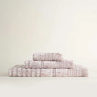 Front view of Maia organic cotton bath hand and washcloth set in Pink Powder neatly arranged to highlight its soft texture and eco friendly design of organic bath towels