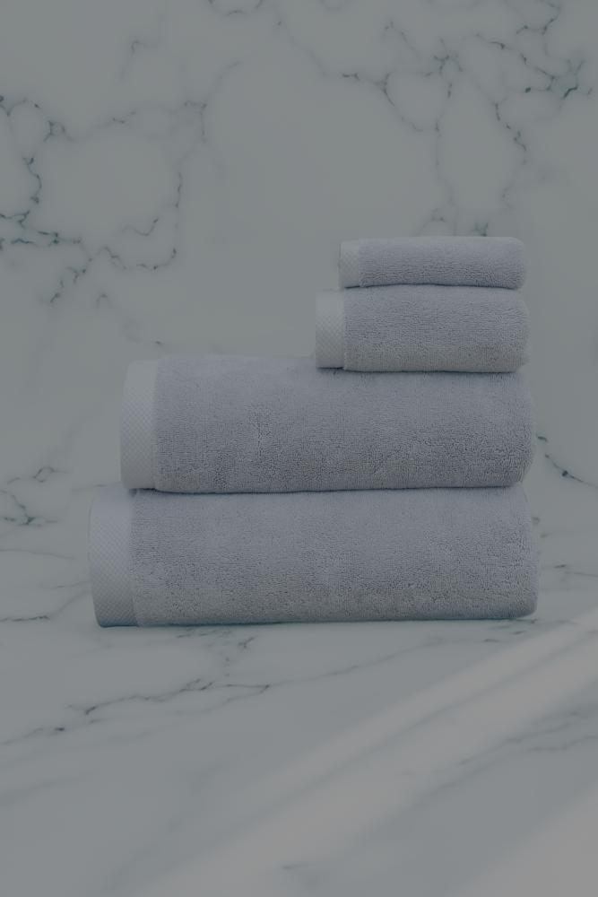 Silver Suede Monte Rosa 820-gram organic Aegean cotton luxury bath towel set with four neatly arranged towels, reflecting natural elegance and luxurious plush softness