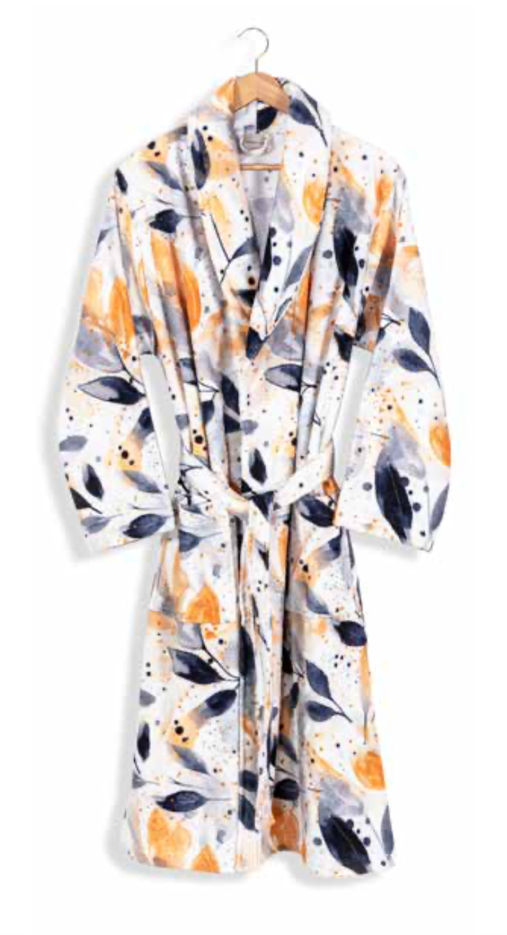 White bathrobe with abstract leaf and splatter pattern in yellow, grey, and black — modern eco-conscious home textile design.