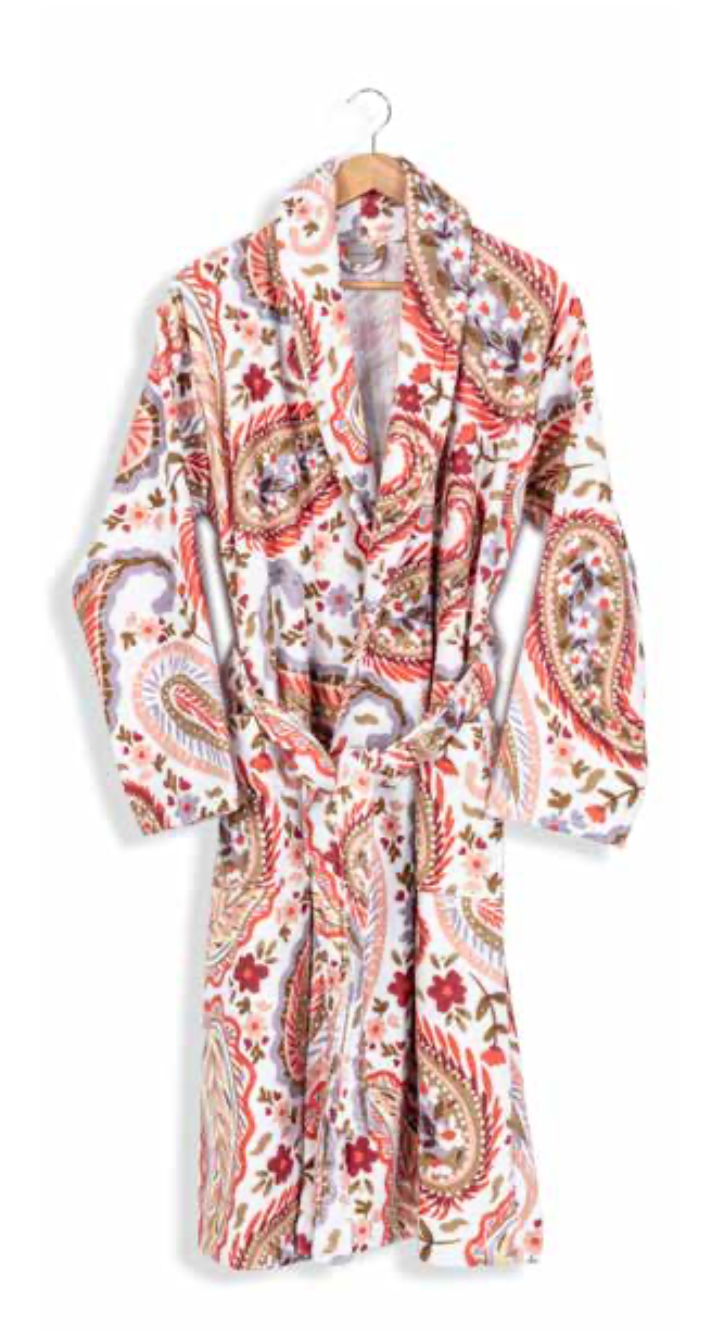 White bathrobe with vibrant red and brown paisley print hanging on wooden hanger — artistic sustainable textile for eco-conscious homewear.