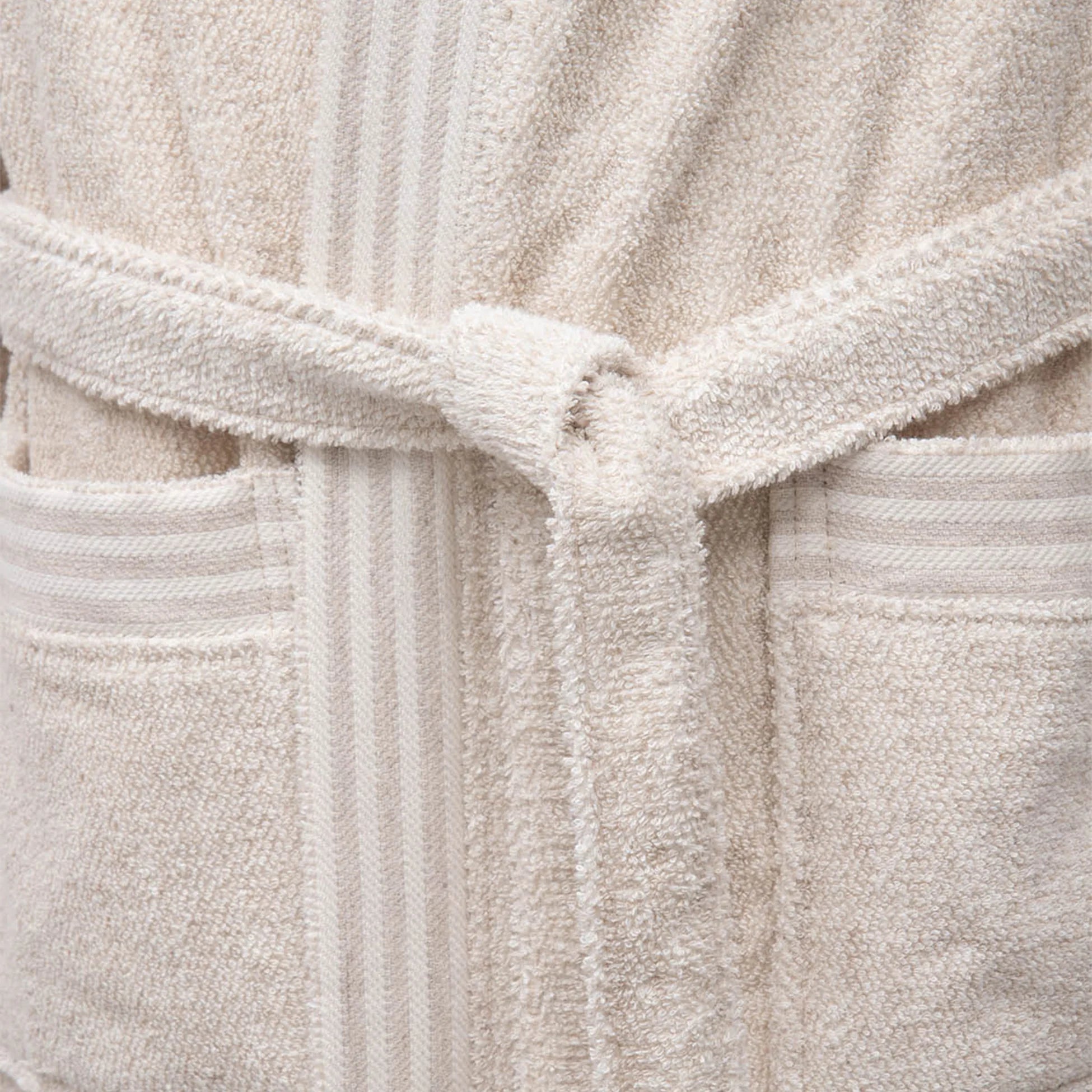 Minoa's Raisa Hemp & Organic Cotton Mens Robe, a sustainable luxury bath robe featuring a delicately designed self-tied belt for comfort and elegance.